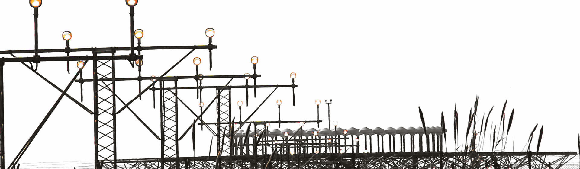 A row of runway approach lights on lattice masts
